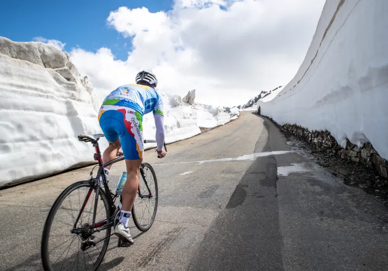 Ciclista en la nieve en la Route des Grandes Alpes